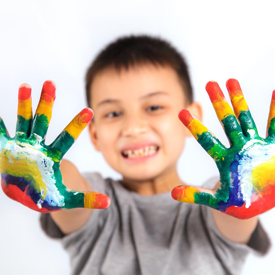 Dreng med maling på hænderne